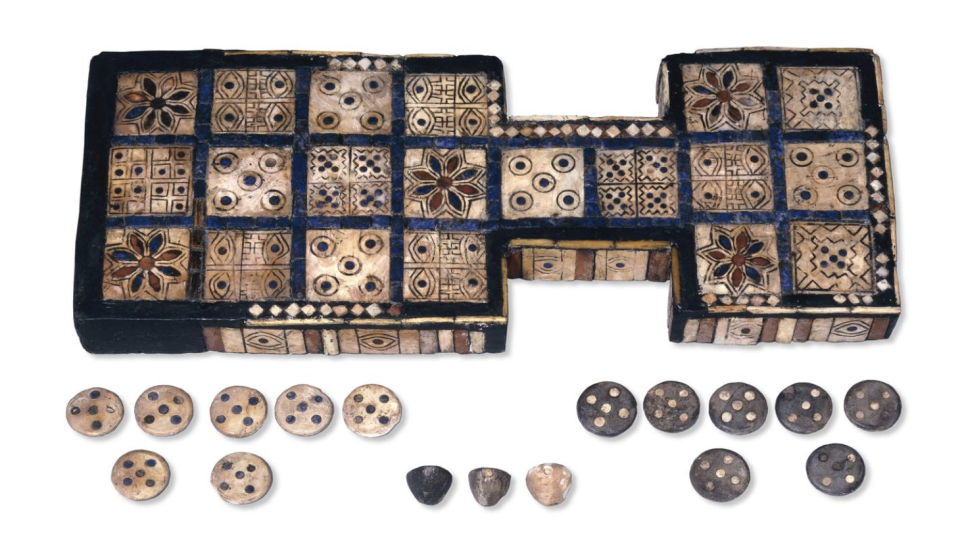 The Royal Game of Ur, a roughly 4,600-year-old Mesopotamian board inlaid with shell and lapis, shown with its counters and tetrahedral dice.
