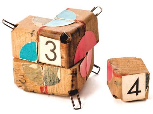 Erno Rubik's early wooden prototype of the Rubik's Cube, made of hand-numbered blocks held with clips and marked with coloured paper dots.