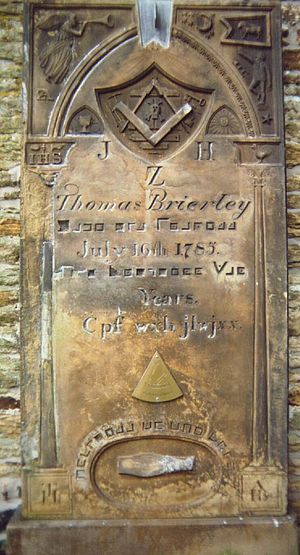 18th-century Masonic gravestone of Thomas Brierley (died 1785) inscribed with Pigpen cipher text alongside Masonic symbols